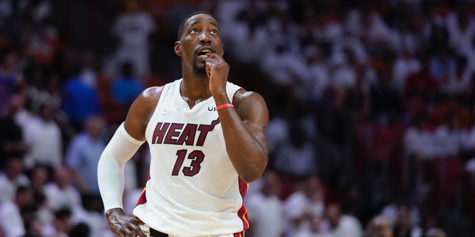 Bam Adebayo looks up during a game while touching his face.