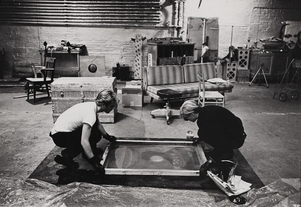 Andy Warhol and Gerard Malanga make a painting , 1964