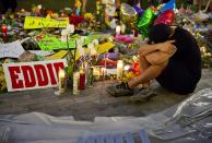 FILE - Jean Dasilva sits next to a makeshift memorial for the victims of a mass shooting at the Pulse Orlando nightclub as he mourns the loss of his friend Javier Jorge-Reyes on June 14, 2016, in Orlando, Fla. The shooter targeted gay patrons in what was a largely Latino crowd. The shooting at a supermarket in Buffalo, New York, on Saturday, May 14, 2022, is the latest example of something that's been part of U.S. history since the beginning: targeted racial violence. (AP Photo/David Goldman, File)