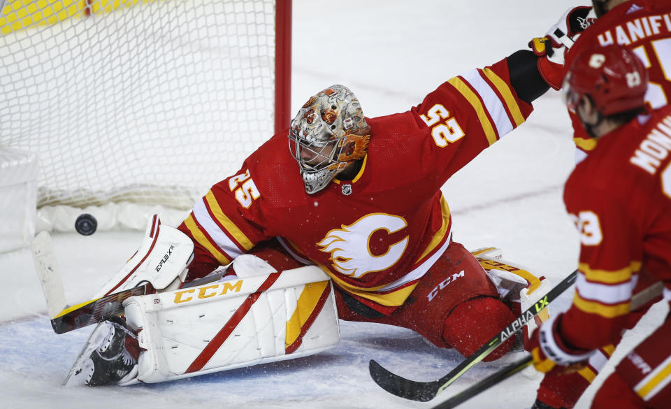 Calgary Flames goalie Jacob Markstrom lets in the winning goal during overtime of an NHL hockey game against the Anaheim Ducks, in Calgary, Alberta, Monday, Oct. 18, 2021. (Jeff McIntosh