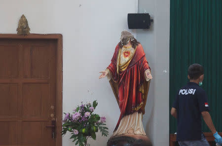 A police investigator is seen inside the Lidwina Catholic Church after a knife-wielding attacker wounded four church-goers in Sleman, Yogyakarta, Indonesia February 11, 2018 in this photo taken by Antara Foto. Antara Foto/Andreas Fitri Atmoko/ via REUTERS