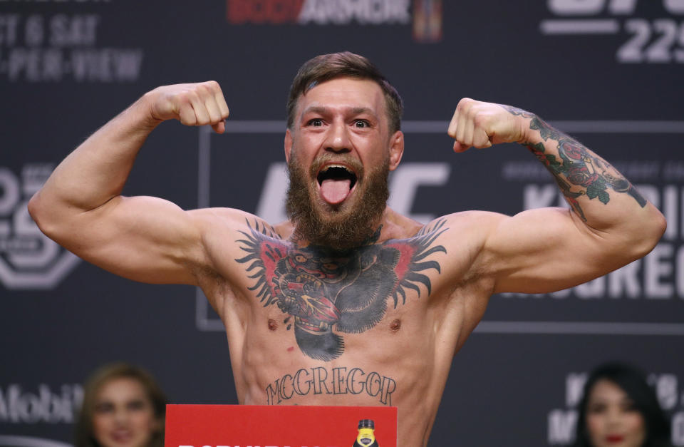 FILE - In this Oct. 5, 2018, file photo, Conor McGregor poses during a ceremonial weigh-in for the UFC 229 mixed martial arts fight in Las Vegas. Superstar UFC fighter McGregor has announced on social media that he is retiring from mixed martial arts. McGregor’s verified Twitter account had a post early Tuesday, March 26, 2019, that said the former featherweight and lightweight UFC champion was making a “quick announcement.”(AP Photo/John Locher, File)