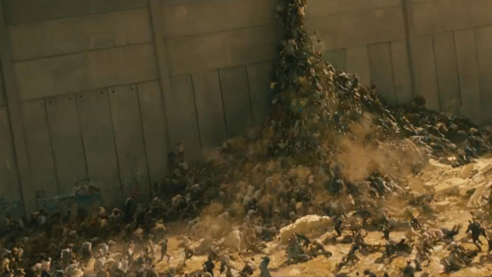 Zombies forming a hill to climb a wall in World War Z.