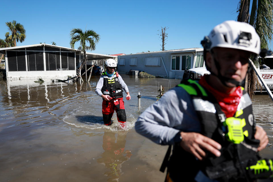 Members of the Texas A&M Task Force 1 Search and Rescue team look for anyone needing help after Hurricane Ian in Fort Myers, Florida, on September 30, 2022.  / Credit: Joe Raedle/Getty Images