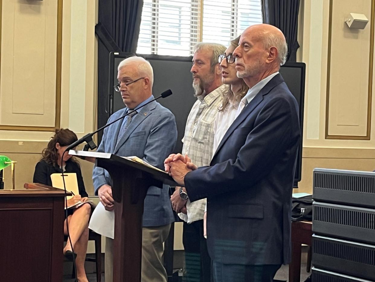 Richard Johnson (with beard) and Trevor Johnson (wearing glasses), stand between their attorneys, from left, Richard Wendel II and Richard Goldberg, for their sentencings in Hamilton County Common Pleas Court on Monday.