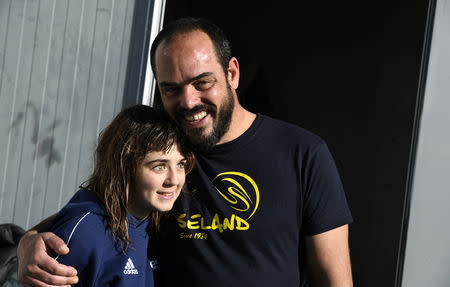 Carmen Lopez Garcia, Spain's first blind female surfer who is to participate in the ISA World Adaptive Surfing Championship, poses with her coach Lucas Garcia after training at Salinas beach, Spain, December 5, 2018. REUTERS/Eloy Alonso