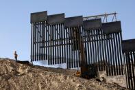 A construction crew works on a bollard-type private border wall, crowd-funded by We Build The Wall group at Sunland Park, New Mexico, as pictured from Ciudad Juarez