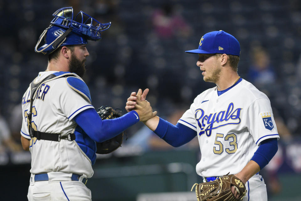 Kansas City Royals relief pitcher Tyler Zuber (53) and catcher Cam Gallahger celebrate the team's 7-2 win over the Chicago White Sox in a baseball game, early Saturday, Sept. 4, 2021, in Kansas City, Mo. (AP Photo/Reed Hoffmann)
