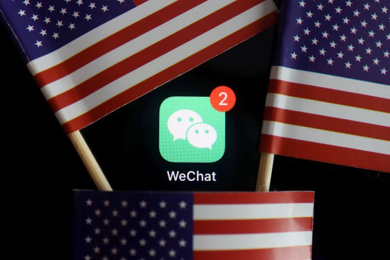 FILE PHOTO: The messenger app WeChat is seen among U.S. flags in this illustration picture