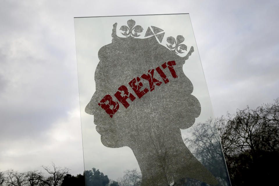 A view of a sculpture by London based Italian artist Matt Marga "One Million Queen" which depicts a profile of Britain's Queen Elizabeth II in London, Dec. 10, 2018. The sculpture has been defaced with Brexit graffiti. (AP Photo/Tim Ireland)