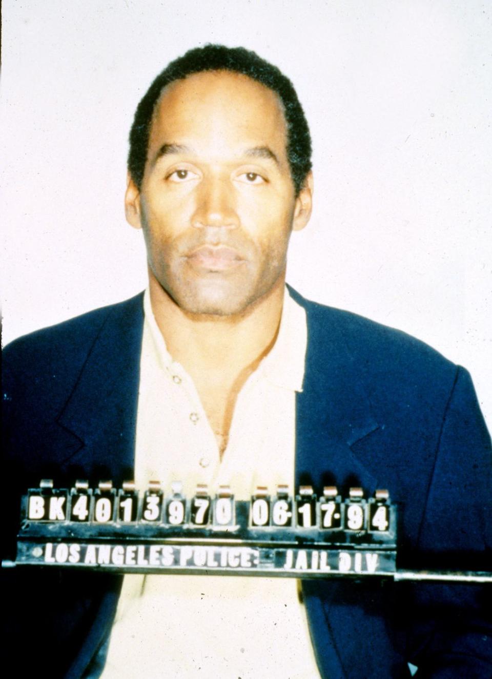 oj simpson stares at the camera with police identification numbers in front of him