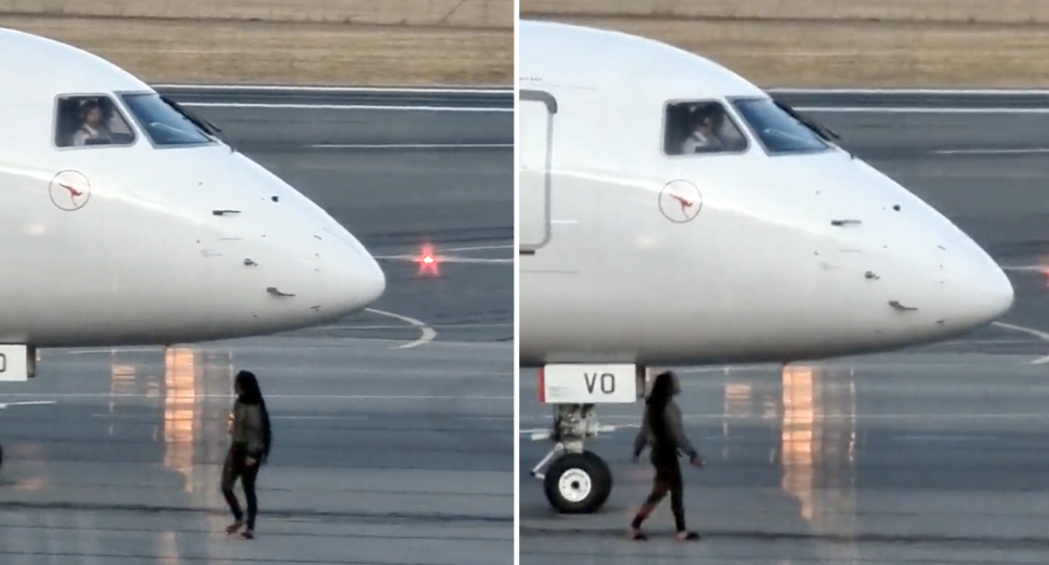 The woman is seen dangerously close to the Qantas Link flight. 