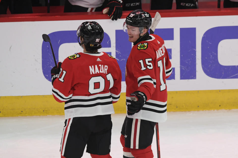 Chicago Blackhawks' Frank Nazar (91) celebrates with teammate Joey Anderson (15) after scoring his first goal in the NHL during the first period of a hockey game against the Carolina Hurricanes, Sunday, April 14, 2024, in Chicago. (AP Photo/Paul Beaty)