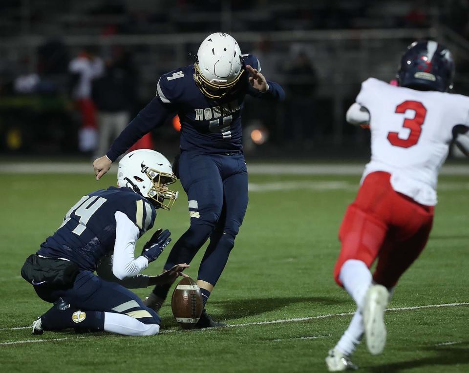 Hoban kicker Charlie Durkin kicks a 40 yard field goal held by teammate Ben Nichols during the second quarter of their Division II regional quarterfinal game against Austintown Fitch at Hoban Friday in Akron. Hoban won 48-28