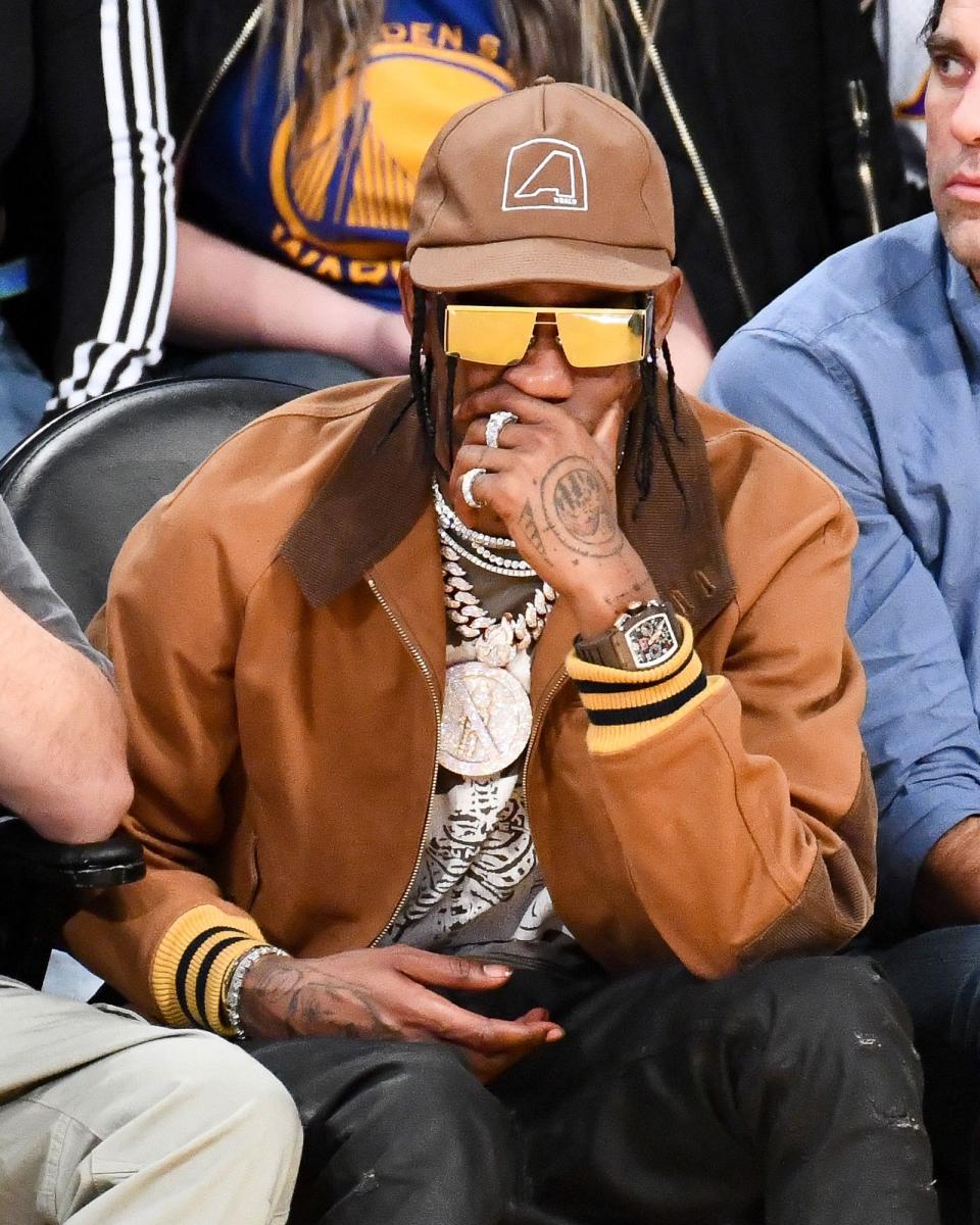 Travis Scott wears his sunglasses at night.