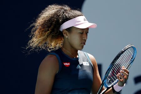 Mar 22, 2019; Miami Gardens, FL, USA; Naomi Osaka of Japan adjusts her strings between points against Yanina Wickmayer of Belgium (not pictured) in the second round of the Miami Open at Miami Open Tennis Complex. Mandatory Credit: Geoff Burke-USA TODAY Sports