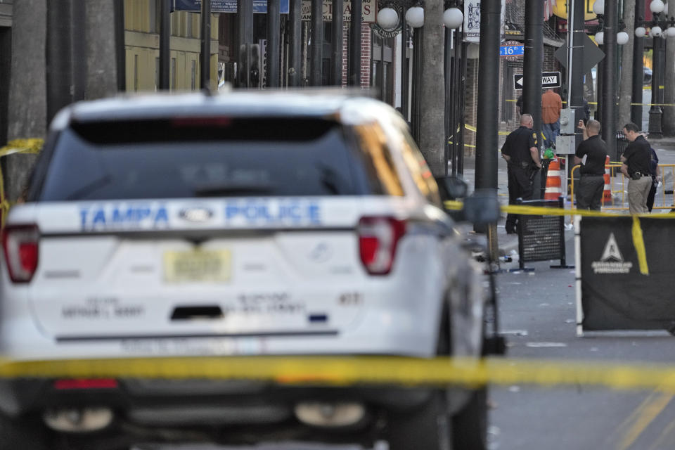 Tampa police officers stand in the street in the Ybor City of Tampa after a shooting Sunday, Oct. 29, 2023. A fight between two groups turned deadly in a shooting on a Tampa street during Halloween festivities. (AP Photo/Chris O'Meara)