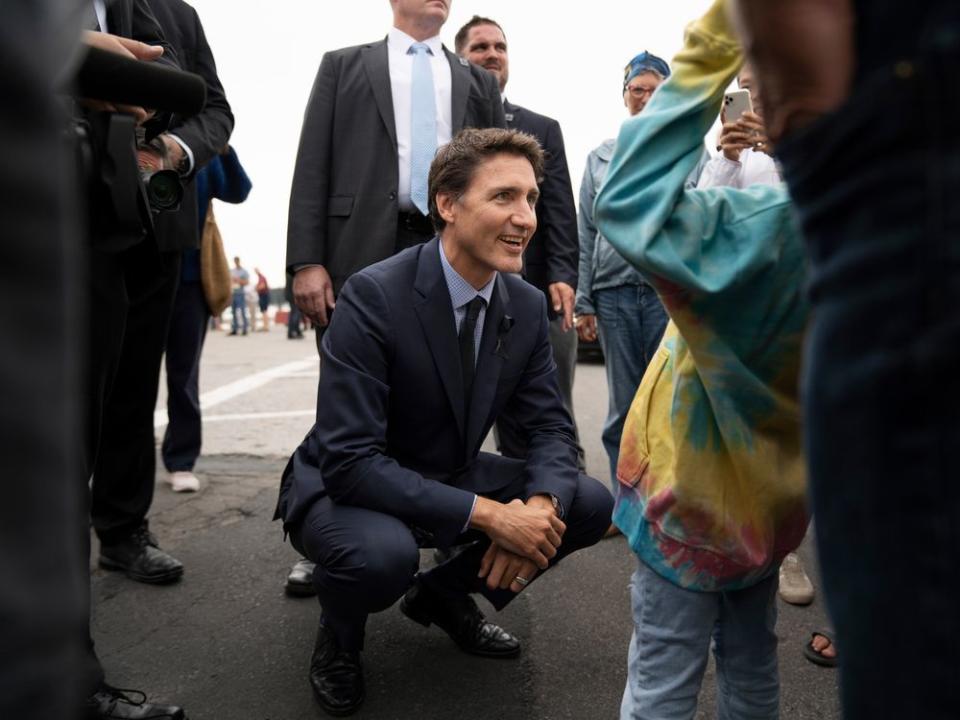 Prime Minister Justin Trudeau greets a young girl in a crowd following an announcement during the Liberal summer caucus retreat in St. Andrews, N.B., Tuesday, Sept. 13, 2022.
