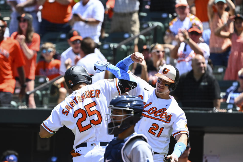 Baltimore Orioles' Anthony Santander (25) is greeted by Austin Hays (21) after hitting a solo home run against Tampa Bay Rays starting pitcher Corey Kluber during the first inning of a baseball game, Sunday, June 19, 2022, in Baltimore. (AP Photo/Terrance Williams)