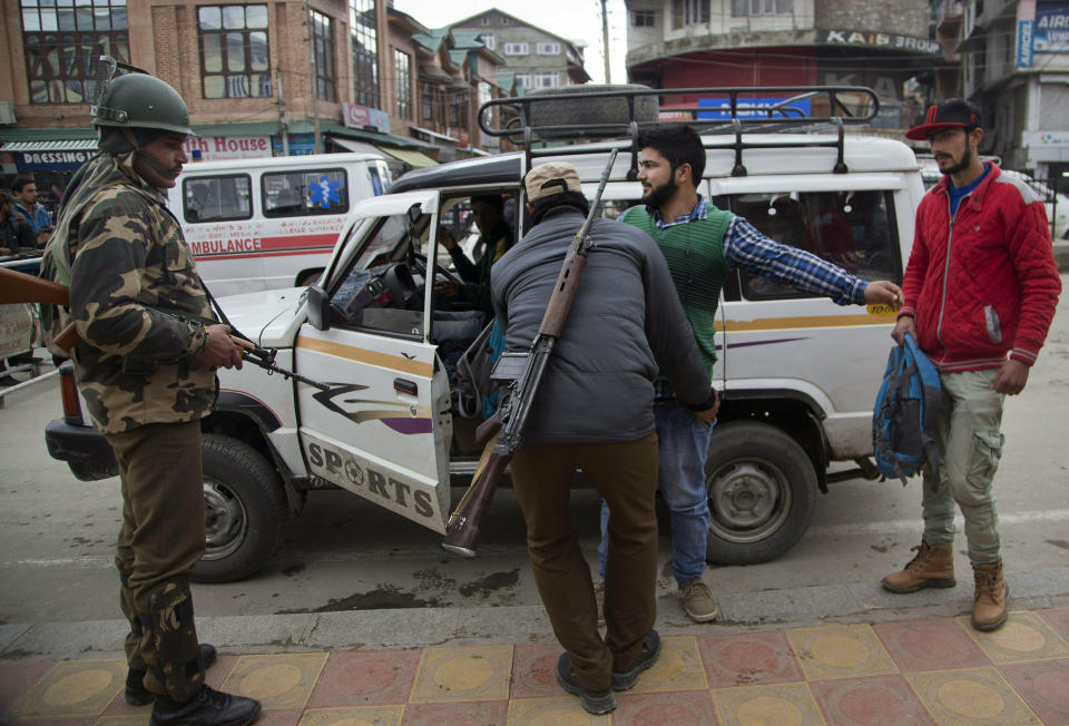 In this Nov. 4, 2015 file photo, a security officer frisks a Kashmiri at a temporary checkpoint in Srinagar, Indian controlled Kashmir. A prominent rights group in Indian-controlled Kashmir is advocating United Nations to establish a commission of inquiry to probe endemic use of torture by government forces who have faced decades long anti-India uprising in the disputed region. (AP Photo/Dar Yasin, File)