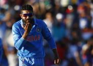 India's Ravindra Jadeja blows a kiss to teammate Virat Kohli, who captured West Indies' last wicket Jason Holder, during his Cricket World Cup match in Perth, March 6, 2015. REUTERS/David Gray