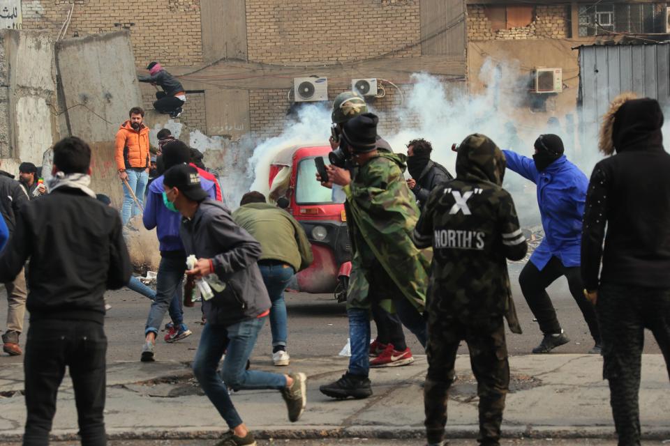 Smoke rise from tear gas fired by security forces during clashes with anti-government protesters in Baghdad, Iraq, Saturday, Jan. 25, 2020. Security forces set fire to anti-government protest tents in the country's south early Saturday and re-opened key public squares in Baghdad that had been occupied by demonstrators for months. (AP Photo/Hadi Mizban)