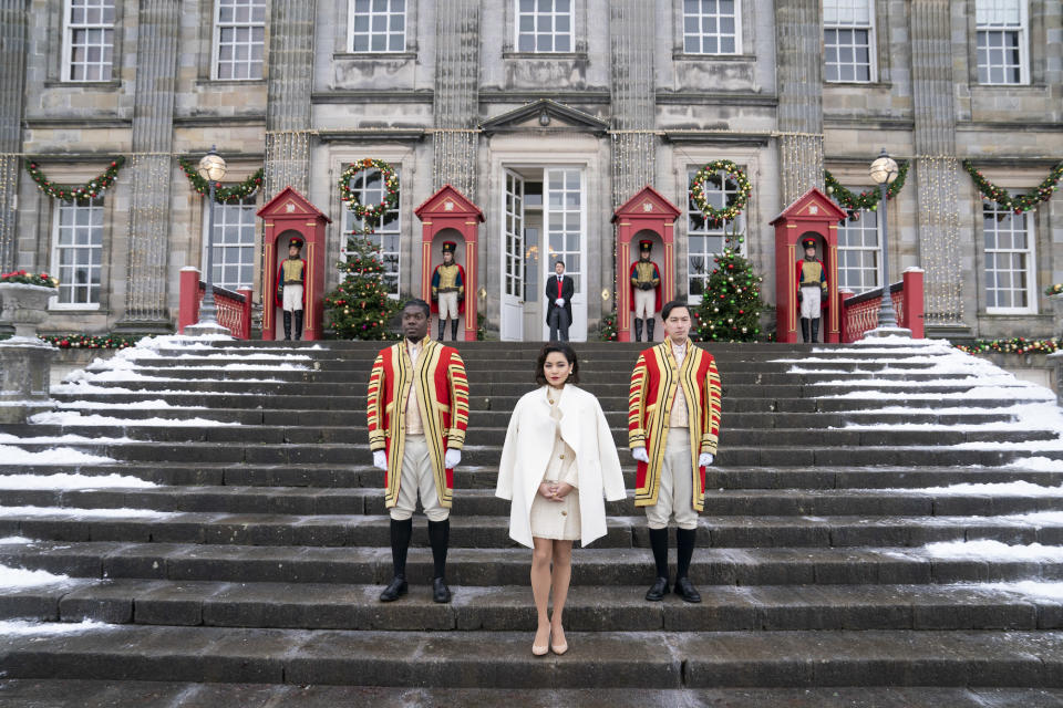 Queen Margaret standing on snowy steps with guards flanking her