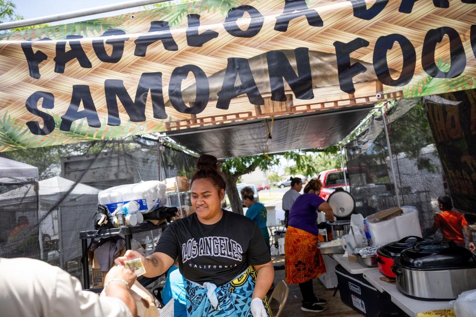 Marjorie Sua serves a customer at Fagaloa Bay Samoan Food’s stand at the second annual Samoan Heritage Festival in Kearns on Wednesday, July 19, 2023. | Spenser Heaps, Deseret News