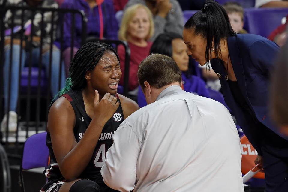 South Carolina head coach Dawn Staley, right, checks on Aliyah Boston while a trainer tends to Boston after an injury during the first half of an NCAA college basketball game against Clemson, Sunday, Nov. 24, 2019, in Clemson, S.C. (AP Photo/Richard Shiro)