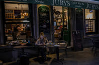 A woman sits outside a bar, in Gibraltar, Thursday, March 4, 2021. Gibraltar, a densely populated narrow peninsula at the mouth of the Mediterranean Sea, is emerging from a two-month lockdown with the help of a successful vaccination rollout. The British overseas territory is currently on track to complete by the end of March the vaccination of both its residents over age 16 and its vast imported workforce. But the recent easing of restrictions, in what authorities have christened “Operation Freedom,” leaves Gibraltar with the challenge of reopening to a globalized world with unequal access to coronavirus jabs. (AP Photo/Bernat Armangue)