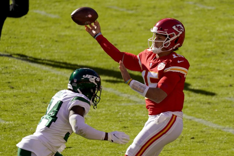 New York Jets cornerback Brian Poole (34) pressures as Kansas City Chiefs quarterback Patrick Mahomes (15) throws a pass in the second half of an NFL football game on Sunday, Nov. 1, 2020, in Kansas City, Mo. (AP Photo/Charlie Riedel)