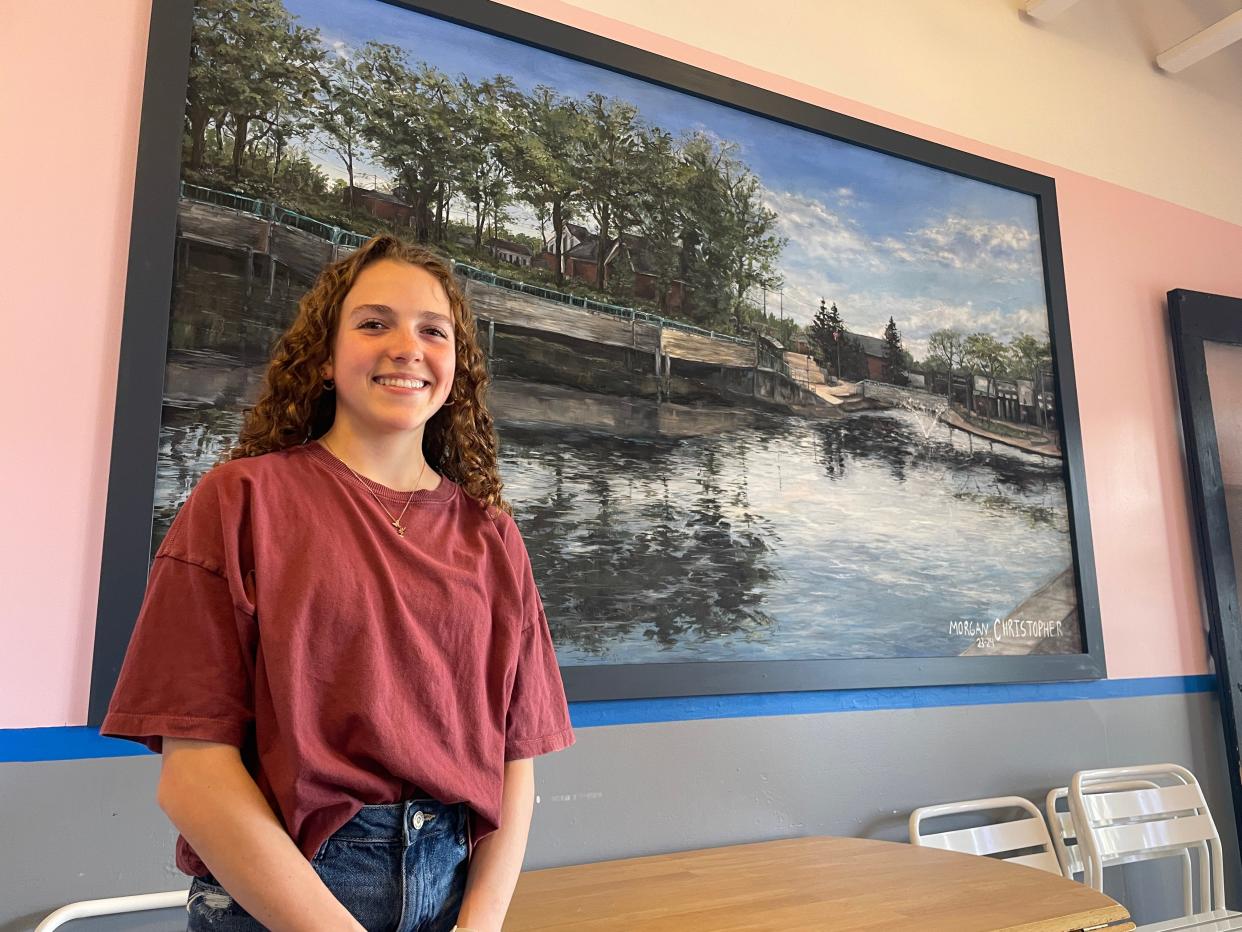 Brighton High School sophomore Morgan Christopher gives The Daily a sneak peek of her mural of the Brighton Mill Pond at Jackie's Custard Co., Wednesday, April 10, 2024.