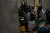 Ukrainian police conduct a security check on passengers before boarding the Kherson-Kyiv train at the Kherson railway station, southern Ukraine, Saturday, Nov. 26, 2022. Fleeing shelling, hundreds of civilians on Saturday streamed out of the southern Ukrainian city whose recapture they had celebrated just weeks earlier. (AP Photo/Bernat Armangue)