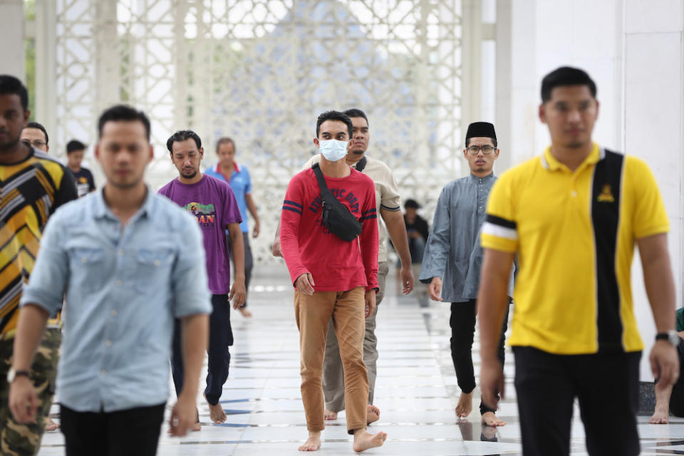 A man wears a protective mask as he attends Friday prayers at Sultan Salahuddin Abdul Aziz Shah Mosque in Shah Alam March 13, 2020. — Picture by Yusof Mat Isa