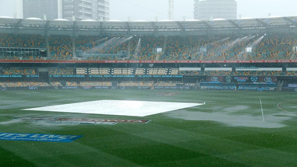 Torrential rain, pictured here lashing the Gabba before the AFL grand final.