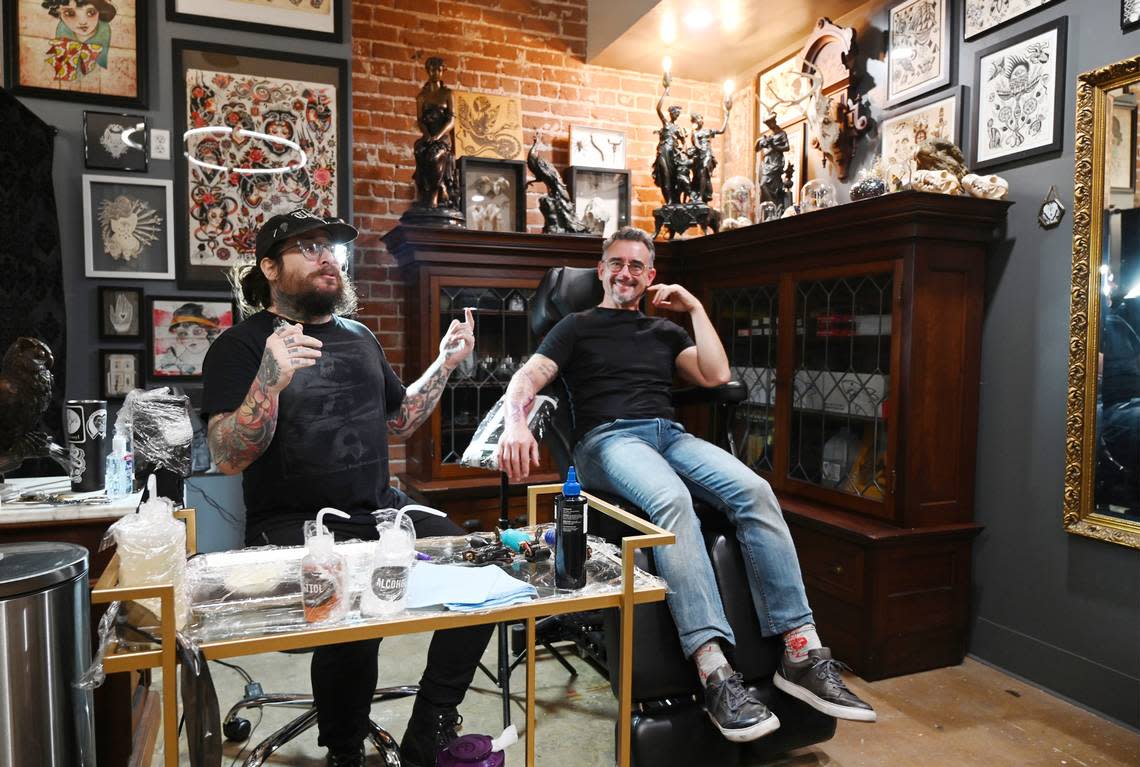 Jason Graham of Widow’s Walk Tattoo, left, talks about his business as Jamin Brazil awaits a new tattoo during a tour of the Sun Stereo Warehouse on Fulton Street Thursday, Aug. 18, 2022 in downtown Fresno. Brazil, along with Reza Assemi, worked together to transform the former historical Ford dealership into the new retail and art work space in the Brewery District.