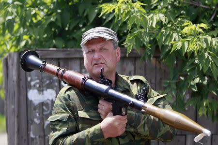 An armed pro-Russian separatist stands guard in Seversk (Siversk), located near the town of Krasny Liman, Donetsk region, June 19, 2014. REUTERS/Shamil Zhumatov