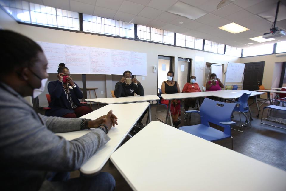 Andre Johnson, CEO of the Detroit Recovery Project, speaks with staff members June 30, 2020.