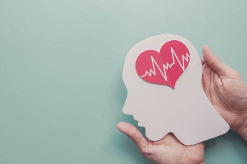 <span class="caption">Substantial savings could be made by improving everyone's mental wellbeing.</span> <span class="attribution"><a class="link " href="https://www.shutterstock.com/image-photo/hands-holding-paper-brain-heart-stroke-1815021524" rel="nofollow noopener" target="_blank" data-ylk="slk:SewCream/ Shutterstock;elm:context_link;itc:0;sec:content-canvas">SewCream/ Shutterstock</a></span>