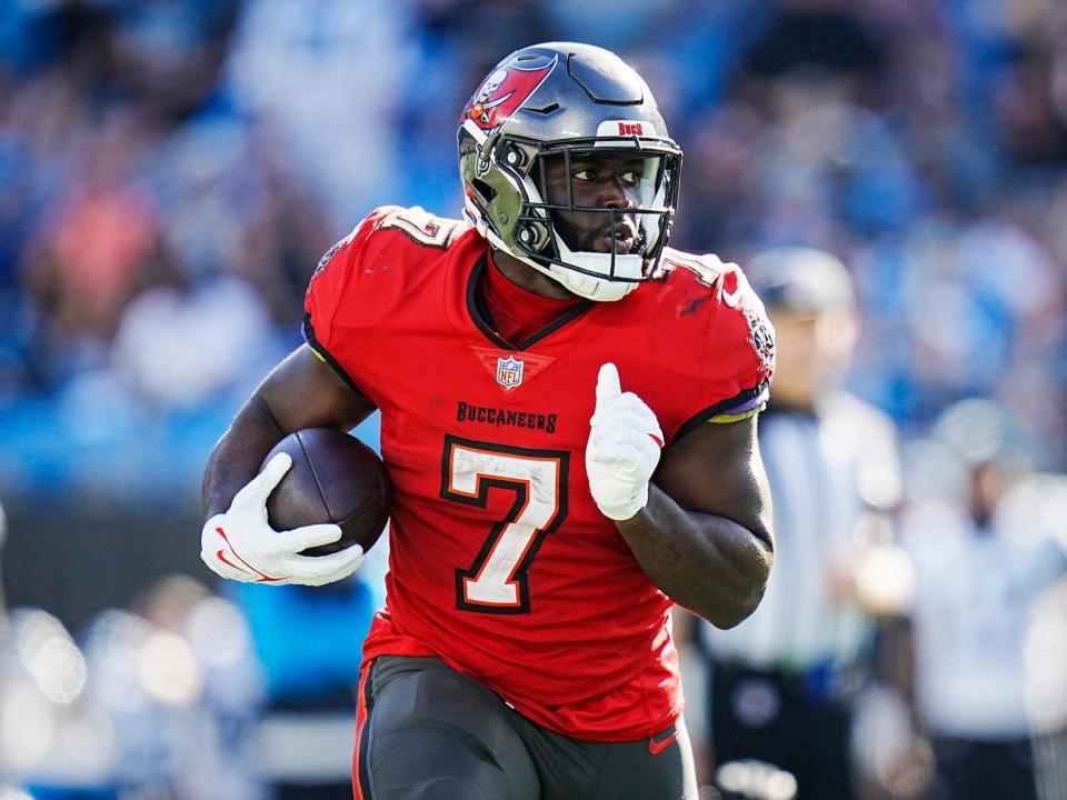 Leonard Fournette runs with the ball during a game.