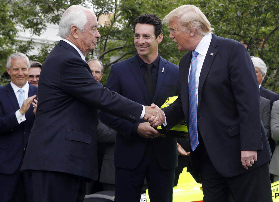 FILE - In this Monday, June 10, 2019, file photo, President Donald Trump shakes hands with racing team owner Roger Penske, left, as driver Simon Pagenaud watches on the South Lawn at the White House in Washington, as the president honored Team Penske for winning the 2019 Indianapolis 500 auto race. President Trump said Thursday, June 20, 2019, that he's awarding a Presidential Medal of Freedom to Penske, the most powerful man in American motorsports. (AP Photo/Patrick Semansky, File)
