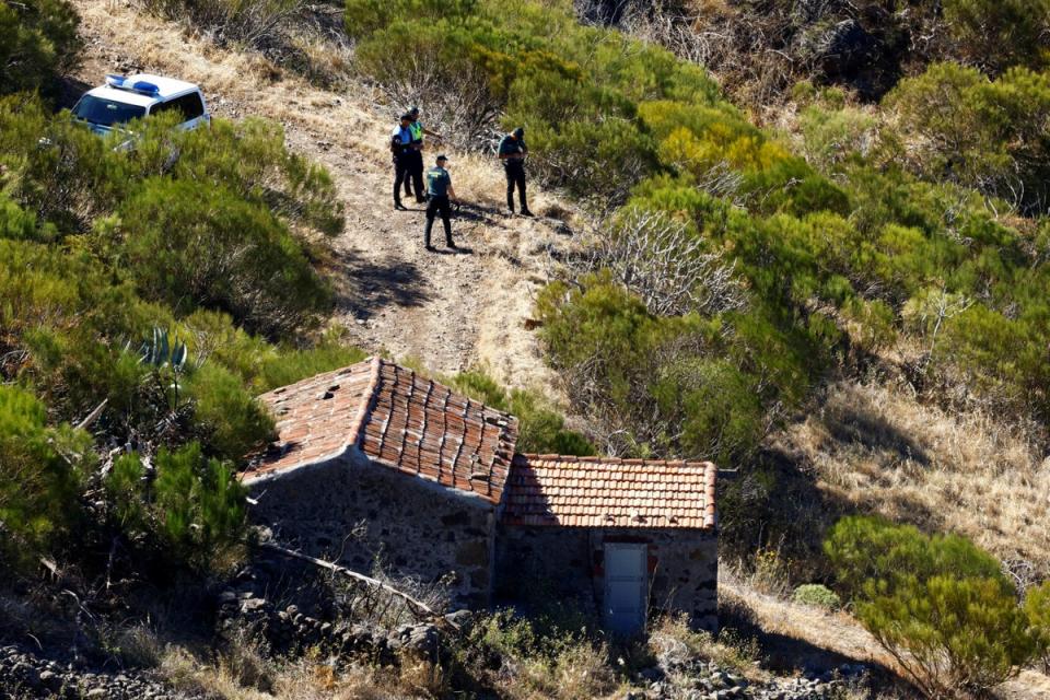 Police officers and voluntary firefighters are searching in the north of the island (REUTERS)