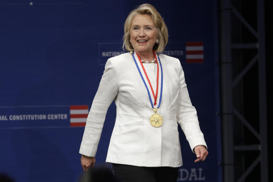 Former Secretary of State Hillary Rodham Clinton walks to the podium after receiving the Liberty Medal during a ceremony at the National Constitution Center, Tuesday, Sept. 10, 2013, in Philadelphia. The honor is given annually to an individual who displays courage and conviction while striving to secure liberty for people worldwide. 