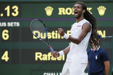 Dustin Brown of Germany celebrates after breaking serve in fourth set during his match against Rafael Nadal of Spain at the Wimbledon Tennis Championships in London, July 2, 2015. REUTERS/Stefan Wermuth