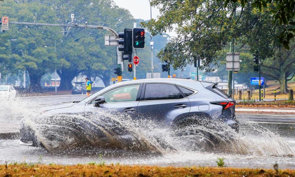 A car drives through a deep puddle in Sydney