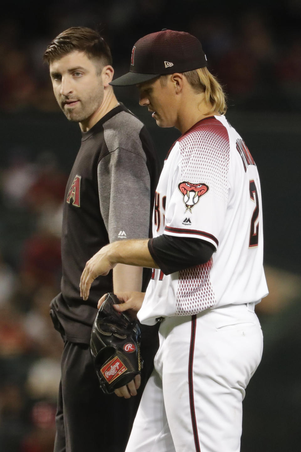 Arizona Diamondbacks starting pitcher Zack Greinke leaves the field with a trainer during the eighth inning of a baseball game against the Pittsburgh Pirates in Phoenix, Wednesday, May 15, 2019. (AP Photo/Matt York)
