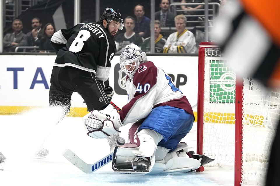 Los Angeles Kings defenseman Drew Doughty, left, tries to get a shot past Colorado Avalanche goaltender Alexandar Georgiev during the second period of an NHL hockey game Wednesday, Oct. 11, 2023, in Los Angeles. (AP Photo/Mark J. Terrill)