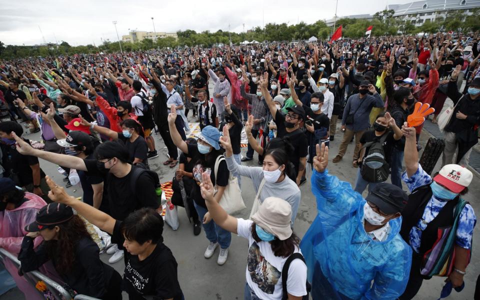 Protesters flash the three-finger-salute at Sanam Luang before marching to send a petition to the King demanding reform of the monarchy - RUNGROJ YONGRIT/EPA-EFE/Shutterstock