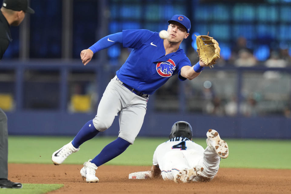 Miami Marlins' Nick Fortes (4) steals second base as Chicago Cubs second baseman Nico Hoerner (2) is late with the tag during the fourth inning of a baseball game, Sunday, April 30, 2023, in Miami. (AP Photo/Marta Lavandier)