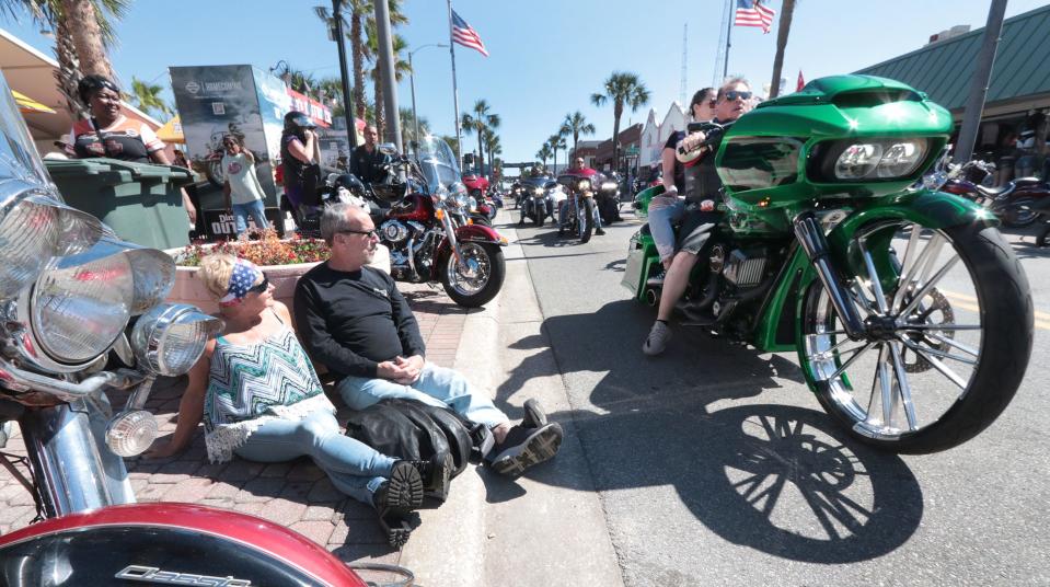 Carolyn and Mike DeVito, of West Virginia, watch the riders cruise Main Street on the closing weekend of Bike Week 2023 in Daytona Beach. The 10-day event generated positive reviews from visitors and local business owners alike.